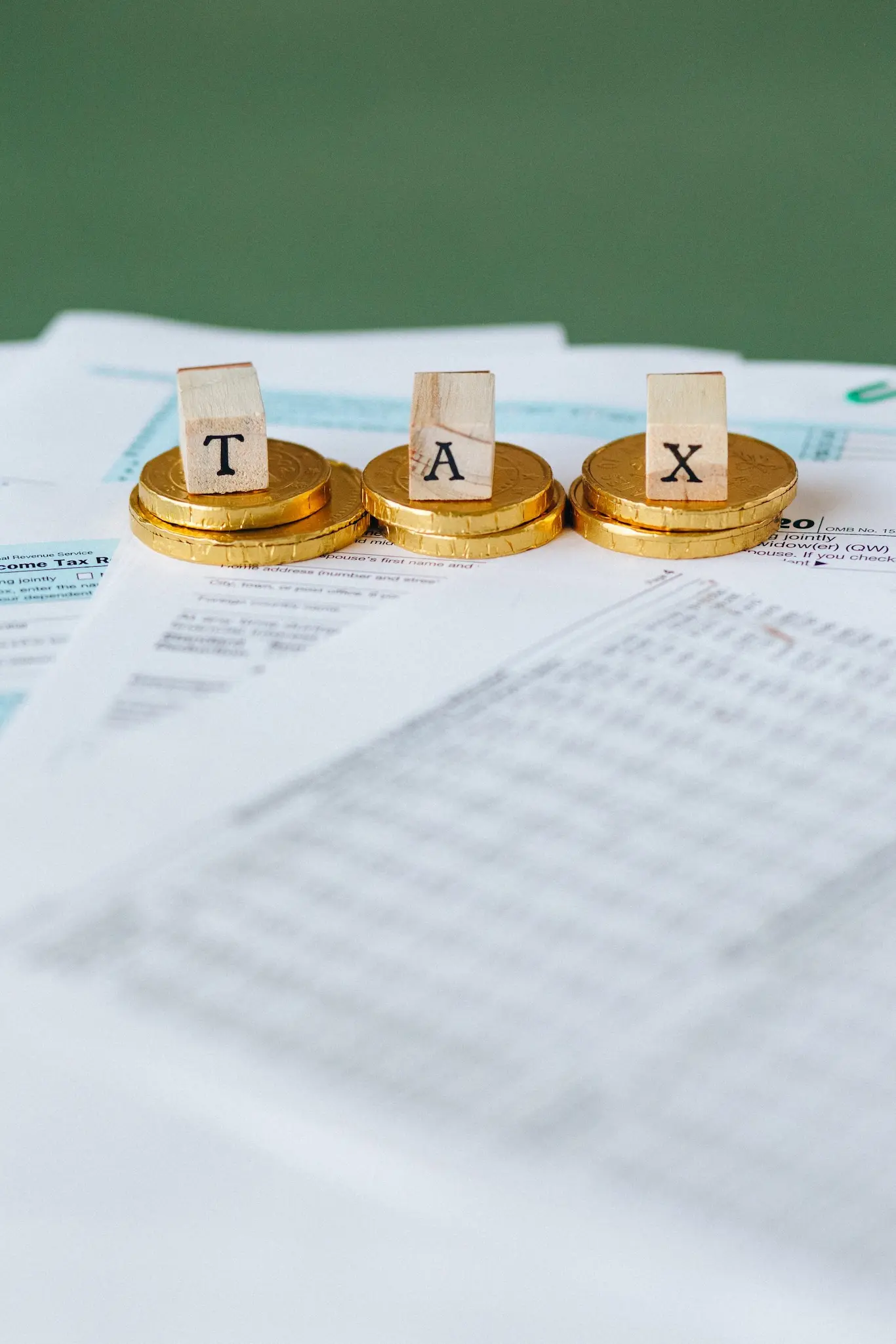 Gold tax documents and coins on a desk