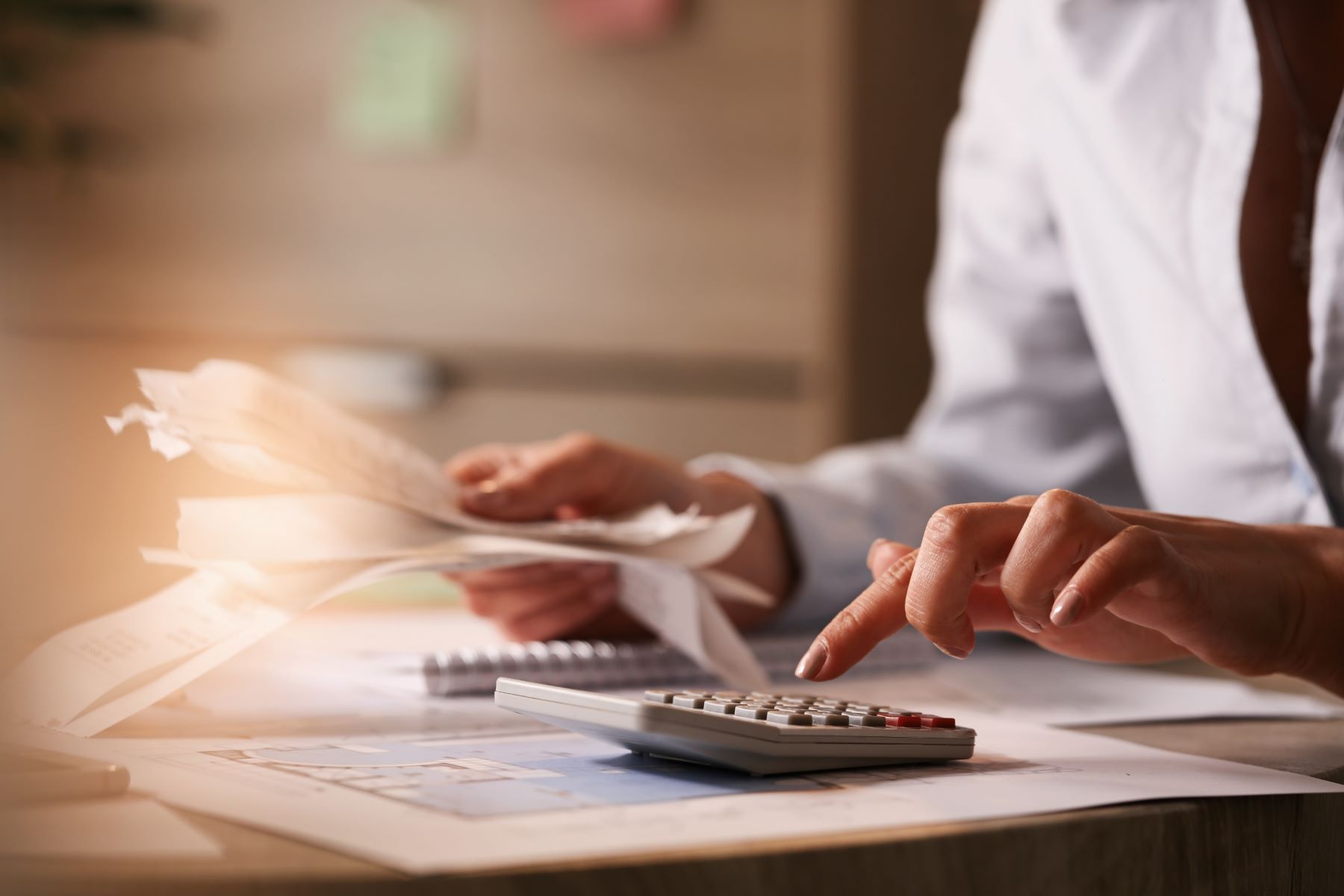 man using calculator to pay tax bills