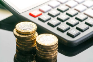 Coins next to a calculator
