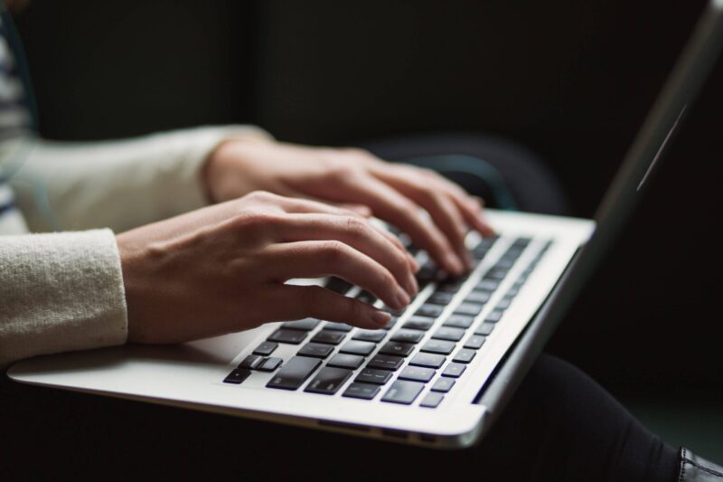 Person typing on a macbook